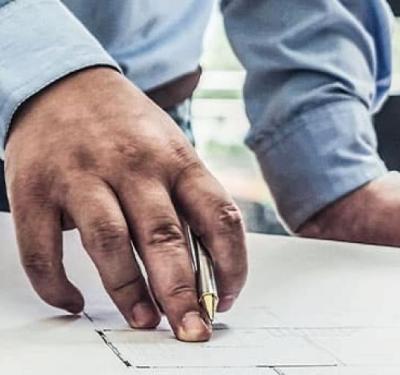 People looking at a blueprint on the table